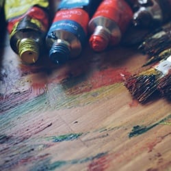 Open painting tubes in the colors of red, yellow and blue